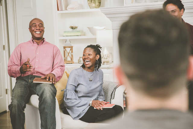 Married Group Laughing and Talking at Small Group in Living Room