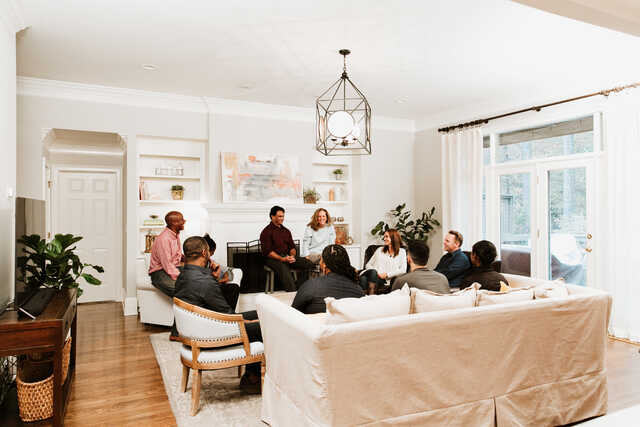 a group of married couples sitting in a living room