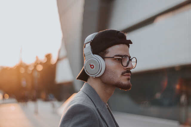 college student listening to headphones